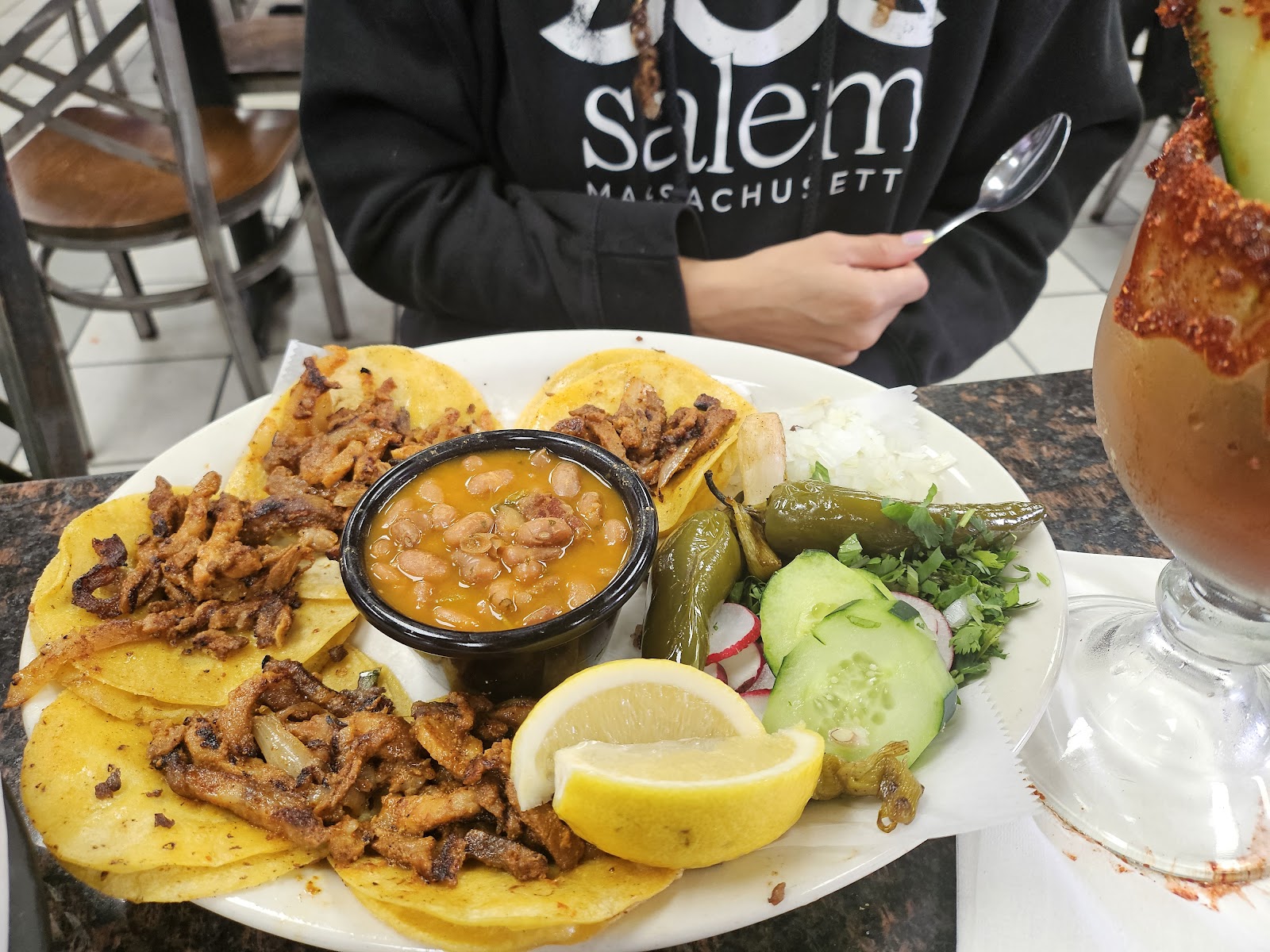 Street tacos plate with beans, grilled jalape&ntilde;o, and lime